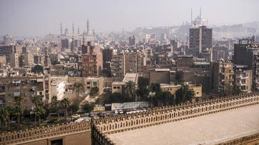 This picture taken on January 11, 2020 from the minaret of the ninth century mosque of Ibn Tulun shows a view of the mosque's roof and a backdrop of the Egyptian capital Cairo, with the 19th century Grand Mosque of Mohamed Ali Pasha (R) situated in the Cairo Citadel and the minarets of the 20th and 14th century mosques of al-Rifai and Sultan Hassan seen in the background (L).