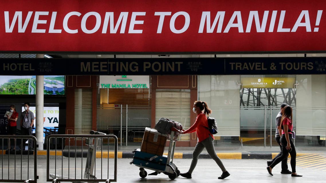 A woman wearing a protective face mask arrives at the Manila's international airport, Philippines on Monday Feb. 3, 2020. (AP)