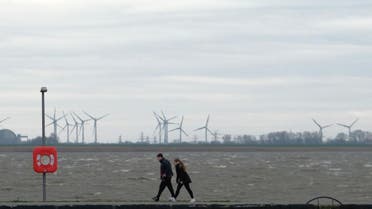 People walk along a seawall at the North Sea in Bremerhaven, northern Germany, on Febuary 9, 2020. (AFP)