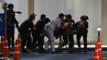 An injured member of Thai security forces is stretchered out after a raid inside the Terminal 21 shopping mall to try to stop a soldier on a rampage after a mass shooting, Nakhon Ratchasima, Thailand. (Reuters)