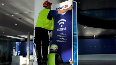 Employees place a banner with information of MWC20 (Mobile World Congress) in Barcelona, Spain, on February 5, 2020. (Reuters)