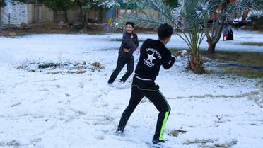 Iraqi boys play with snow in the Shia city of Karbala on February 11, 2020. (AFP)