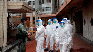 Police in protective gear wait to evacuate residents from a public housing building, following the outbreak of the novel coronavirus, in Hong Kong, China February 11, 2020. (Reuters)