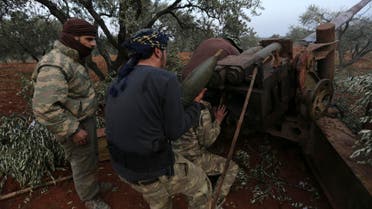 Syrian opposition fighters prepare to shoot a howitzer toward the government positions near the village of Nerab, in Idlib province on Feb. 6, 2020. (AP)