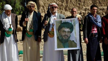 Huthi militiamen hold posters depicting Lebanon's Hezbollah chief Hassan Nasrallah during a gathering to show their support to Hezbollah following the Gulf states' announcement declaring the group a " terrorist organization", in the capital Sanaa, on March 3, 2016. (AFP)