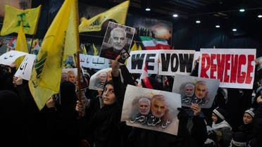 Supporters of Hezbollah leader Sayyed Hassan Nasrallah wave flags and placards that say "we vow revenge," ahead of the leader's televised speech in a southern suburb of Beirut. (AP)