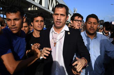 Venezuelan opposition leader and self-proclaimed acting president Juan Guaido (C) arrives at Simon Bolivar International Airport in Maiquetia, Vargas state, Venezuela. (AFP)