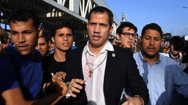 Venezuelan opposition leader and self-proclaimed acting president Juan Guaido (C) arrives at Simon Bolivar International Airport in Maiquetia, Vargas state, Venezuela. (AFP)