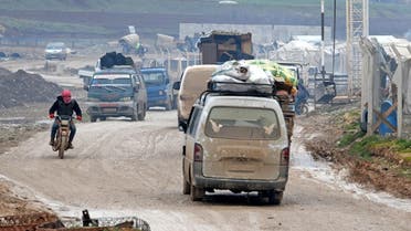 Displaced Syrians flee the countryside of Aleppo and Idlib provinces towards Syria's northwestern Afrin district near the border with Turkey on February 13, 2020. (AFP)