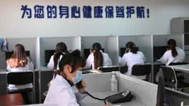 A hotline operator for a free counselling service answers a phone while wearing a face mask, as the country is hit by an outbreak of the novel coronavirus, in Shenyang, Liaoning province, China February 12, 2020. (Photo: Reuters)