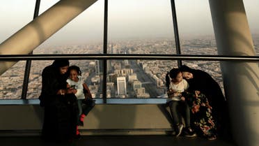 women hold their daughters as they visit the Four Seasons Skyline Tower, in Riyadh, Saudi Arabia. (AP)