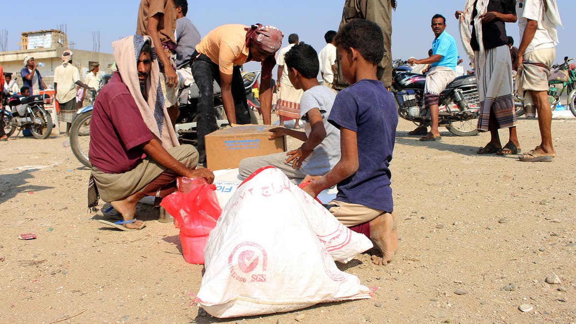 Displaced Yemenis receive humanitarian aid, donated by the World Food Programme (WFP) in cooperation with the Danish Refugee Counci ( DRC), in the northern province of Hajjah on December 30, 2019. Tens of thousands of people, most of them civilians, have been killed since Saudi Arabia and its allies intervened in March 2015 in support of the beleaguered government. The fighting has also displaced millions and left 24.1 million -- more than two-thirds of the population -- in need of aid.