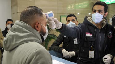 Egyptian Quarantine Authority employees prepare to scan body temperature for incoming travellers at Cairo International Airport on February 1, 2020, amidst efforts to detect possible cases of SARS-like Wuhan coronavirus (novel coronavirus 2019-nCoV).