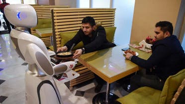A waitress robot, named Timea, delivers food to customers at a Times Fast Food restaurant in Kabul on February 13, 2020. (AFP)