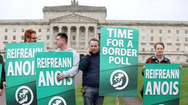 (FILES) In this file photo taken on January 31, 2020 Sinn Fein activists protest at the Parliament Buildings on the Stormont Estate in Belfast on January 31, 2020 against Brexit and call for a border poll on Irish Unity. A strong showing in the Irish general election on February 8, 2020 for Republican party Sinn Fein could result in their flagship policy of reuniting the Republic of Ireland and Northern Ireland becoming a key part of the next government's agenda.