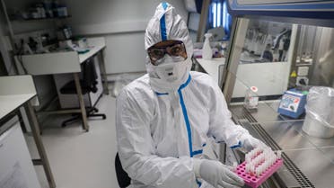 A laboratory operator wearing a protective gear handles patients' samples in a laboratory of the National Reference Center (CNR) for respiratory viruses at the Institut Pasteur in Paris on January 28, 2020. The CNR analyses the tests for respiratory viruses among which coronavirus. The deadly new coronavirus that has broken out in China, 2019-nCoV, has so far killed 106 people and infected over 4,000 -- the bulk of them in and around Wuhan.