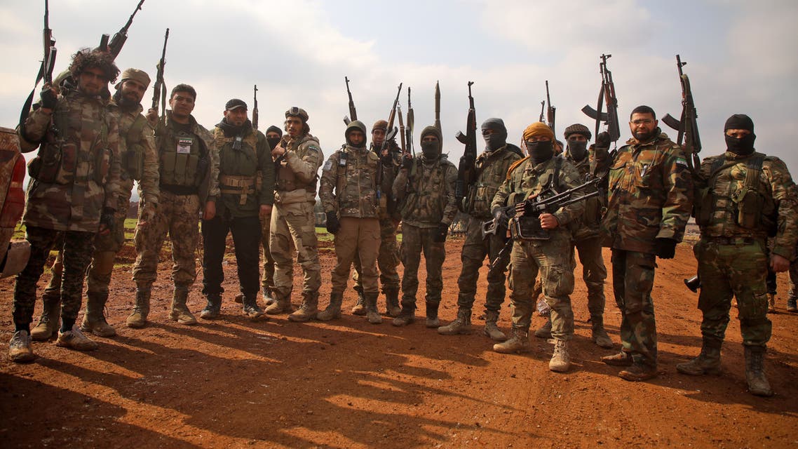 Turkish-backed Syrian fighters load a make-shift rocket launcher mounted on the back of a pickup truck in the village of Miznaz, on the western outskirts of Aleppo province, on February 14, 2020 as they prepare for a counter-offensive against advancing government forces in the Aleppo countryside.