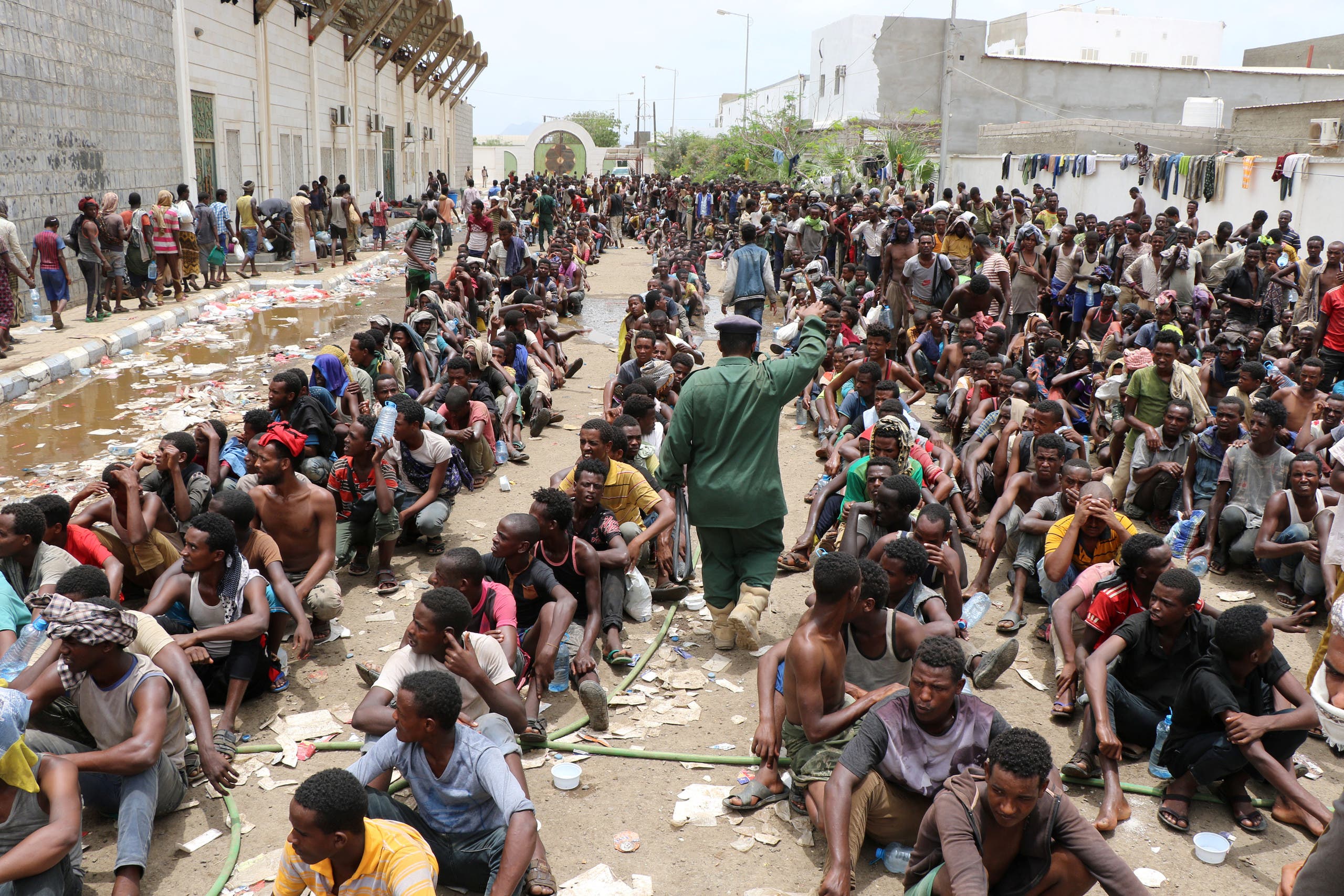 Ethiopian migrants, stranded in war-torn Yemen, sit on the ground of a detention site pending repatriation to their home country, in Aden, Yemen April 24, 2019. (Reuters)