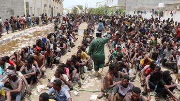 Ethiopian migrants, stranded in war-torn Yemen, sit on the ground of a detention site pending repatriation to their home country, in Aden, Yemen April 24, 2019. REUTERS/Fawaz Salman
