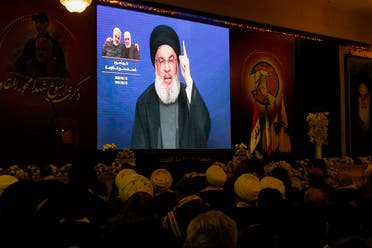 Hezbollah supporters watch as the group's leader Hasan Nasrallah delivers a speech on a screen in the southern Lebanese city of Nabatieh on January 12, 2020. (AFP)