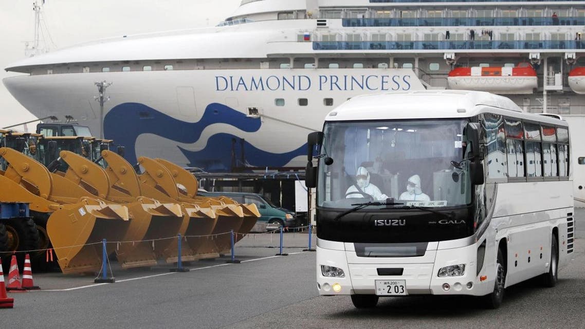 A driver wearing protective suits is seen inside a bus which believed to carry elderly passengers of the cruise ship Diamond Princess, at Daikoku Pier Cruise Terminal in Yokohama, south of Tokyo, Japan. (Photo: Reuters)