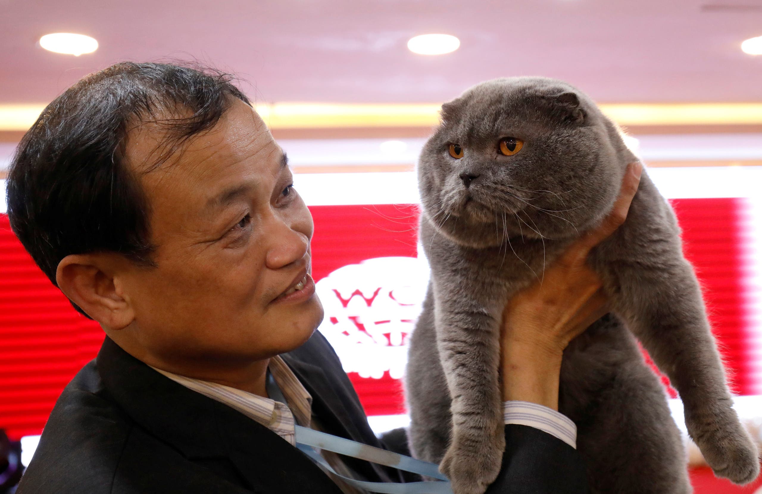Dinh Chau Hieu Tam holds his cat during the Vietnam's first cat show in Hanoi, Vietnam February 16, 2020. REUTERS