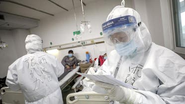 A medical worker in protective suit checks a patient's records at Jinyintan hospital in Wuhan, the epicentre of the novel coronavirus outbreak, in Hubei province, China February 13, 2020. (Reuters)