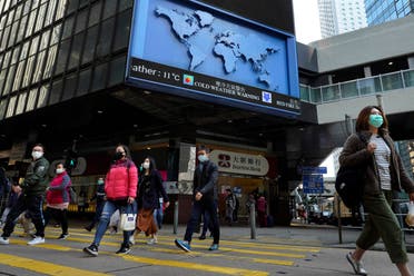 People wearing face mask walk at a downtown street in Hong Kong. (AP)