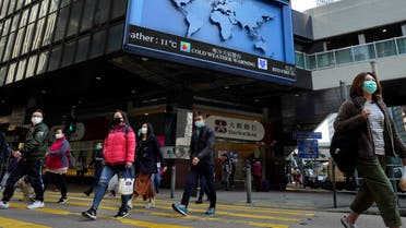 People wearing face mask walk at a downtown street in Hong Kong. (AP)