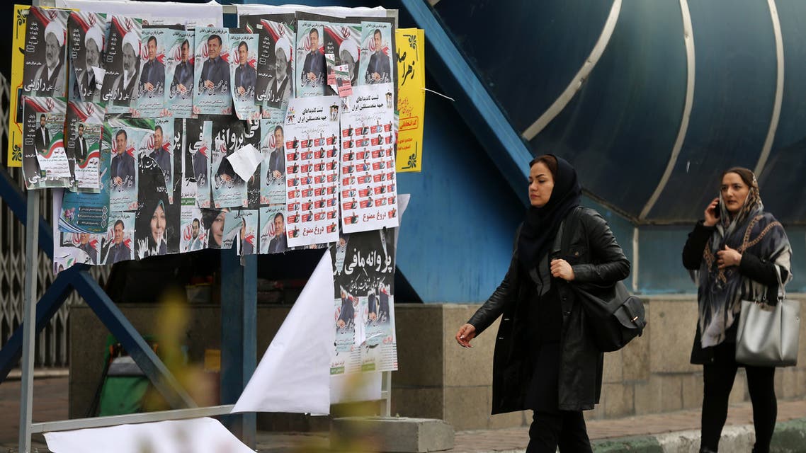 Iranian women walk past electoral posters and fliers during the last day of election campaign in the capital Tehran on February 19, 2020. Iran's electoral watchdog today defended its decision to disqualify thousands of candidates for a crucial parliamentary election in two days, as a lacklustre campaign neared its end. Conservatives are expected to make an overwhelming resurgence in Friday's election, which comes after months of steeply escalating tensions between Iran and its decades-old arch foe the United States.