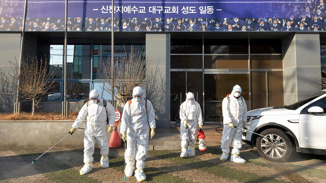 In this Wednesday, Feb. 19, 2020, photo, workers wearing protective gears spray disinfectant against the coronavirus in front of a church in Daegu, South Korea. - AP