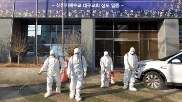 In this Wednesday, Feb. 19, 2020, photo, workers wearing protective gears spray disinfectant against the coronavirus in front of a church in Daegu, South Korea. - AP