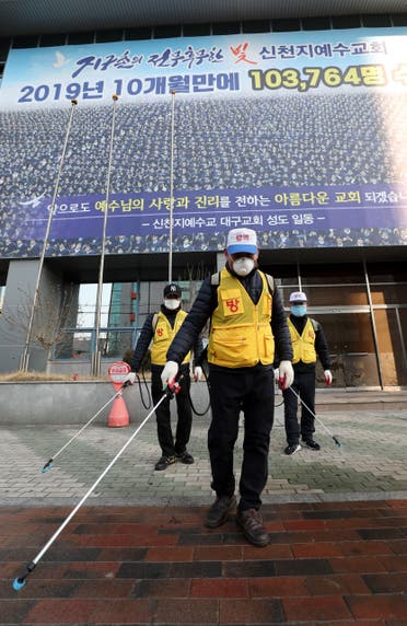 Korean staff disinfect outside the Shincheonji Church of Jesus, Korea, after a coronavirus outbreak - AFP