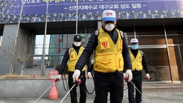 Korean staff disinfect outside the Shincheonji Church of Jesus, Korea, after a coronavirus outbreak - AFP