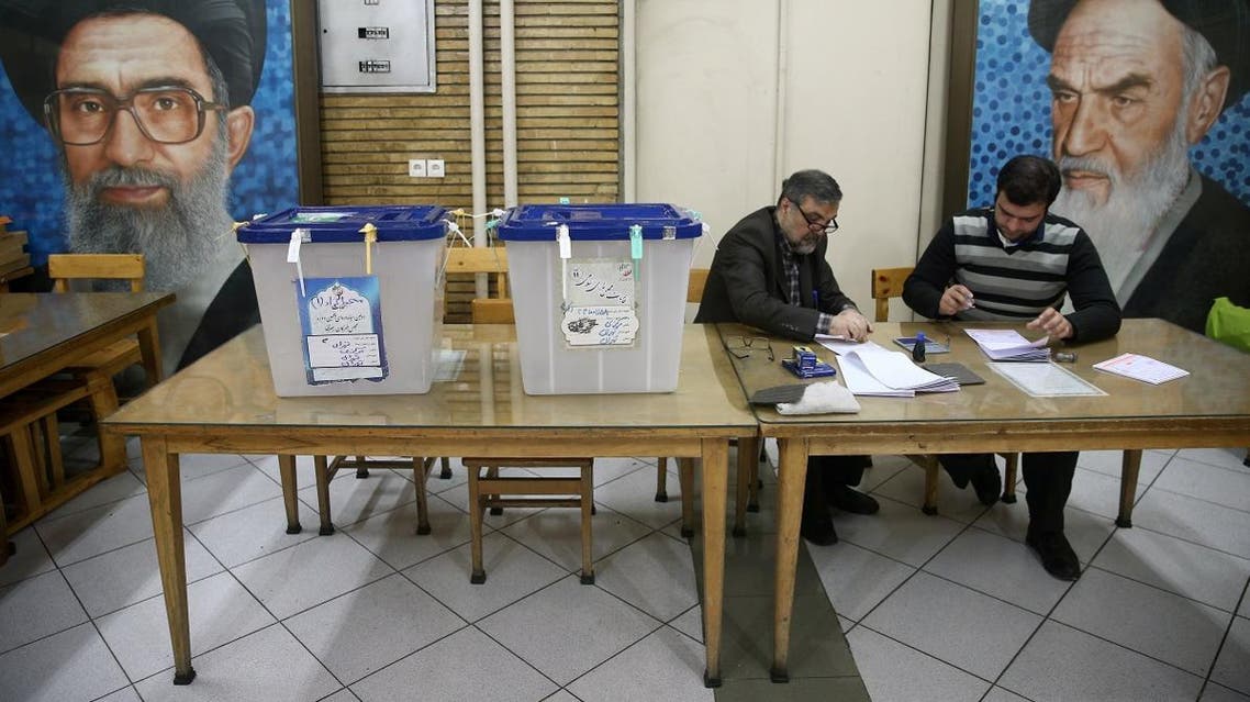 Poll workers are seen during parliamentary elections at a polling station in Tehran. (Reuters)