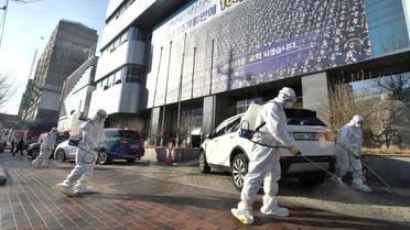 Workers from a disinfection service company sanitize a street in front of a branch of the Shincheonji Church of Jesus the Temple of the Tabernacle of the Testimony where a woman known as "Patient 31" attended a service in Daegu, South Korea, February 19, 2020. Yonhap via REUTERS