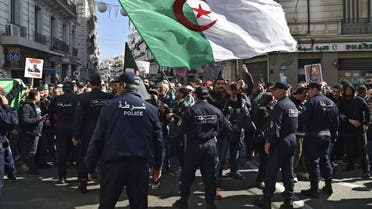 Members of the Algerian police block the progress of an anti-government demonstration heading towards the presidential palace in the capital Algiers, on February 22, 2020. (AFP)