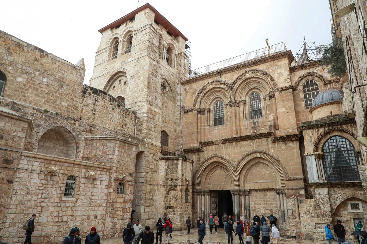 People walk outside the Church of the Holy Sepulchre in the Old City of Jerusalem on January 21, 2020. (AFP)