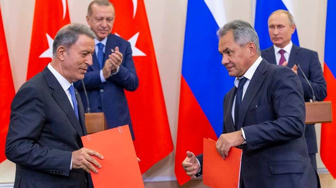 Russian Defense Minister Sergei Shoigu (frontR) exchanges documents with Turkish Defense Minister Hulusi Akar (frontL). afp