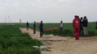 Red Crescent medics recover the body of a martyr from the site, east of Khan Yunis. (Supplied)