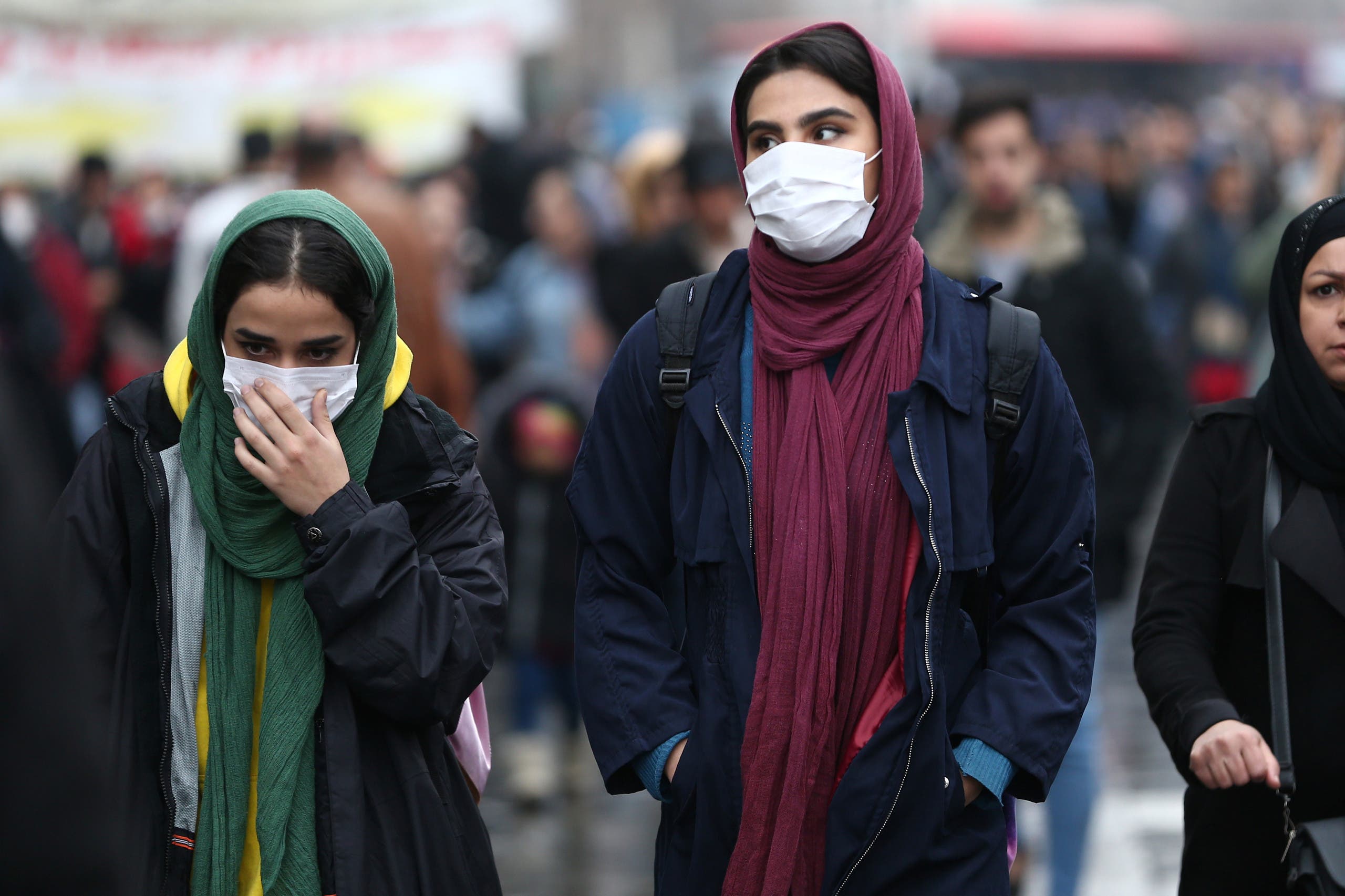 Iranian women wear protective masks to prevent contracting a coronavirus, as they walk at Grand Bazaar in Tehran, Iran. (Reuters) 