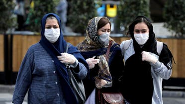 People wear masks to help guard against the coronavirus on a street in Tehran on Feb. 23, 2020. (AP)