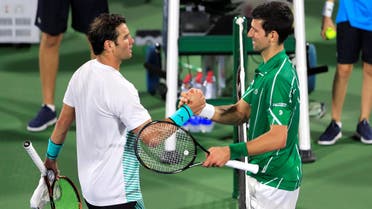 Serbia’s Novak Djokovic shakes hands with Tunisia’s Malek Jaziri after their match at Dubai Duty Free Tennis Stadium on February 24, 2020.  (Reuters)