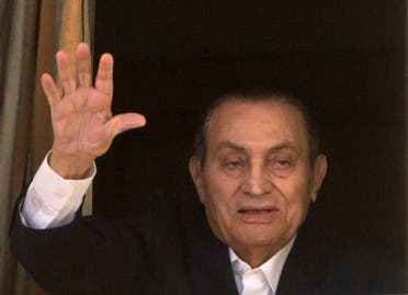 Former President Hosni Mubarak waves to his supporters from his room at the Maadi Military Hospital. (File photo: AP)