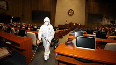 Employees from a disinfection service company sanitize the National Assembly in Seoul, South Korea, on February 25, 2020. (Reuters)