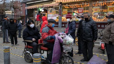 Residents wear masks and line up to enter a supermarket which is controlling the numbers of shoppers in Beijing, China on February 25, 2020. (AP)