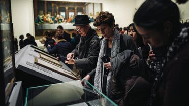 Visitors look at artefacts during the night and free opening of the 'Leonardo da Vinci' exhibition at The Louvre Museum on February 21, 2020 in Paris. (AFP)