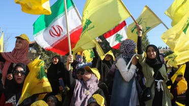 Female supporters of the Lebanese Shiite militant movement Hezbollah wave the group's flag during a commemoration marking the 13th anniversary of the end of the 2006 war with Israel. (File photo: AFP)
