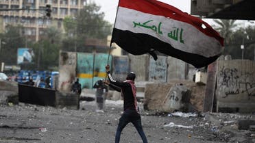 An Iraqi protester waves the national flag amid clashes with riot police at Baghdad's al-Khilani Square on February 19, 2020. (File photo: AFP)