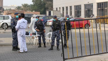 Members of Kuwait's national guard wearing safety masks keep watch outside a hotel in the capital where Kuwaitis returning from Iran are quarantined and tested for coronavirus COVID-19, on February 24, 2020. (AFP)
